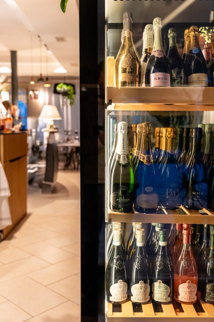 La vetrina dei vini con uno scorcio della sala di Follia Beach